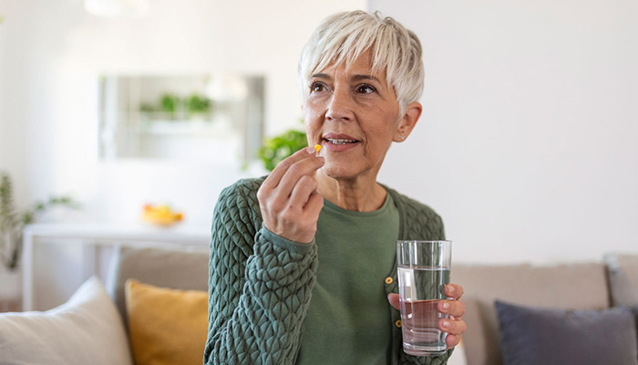 Senior woman taking a vitamin