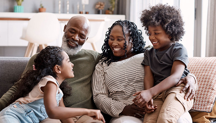 African American family sitting together on couch